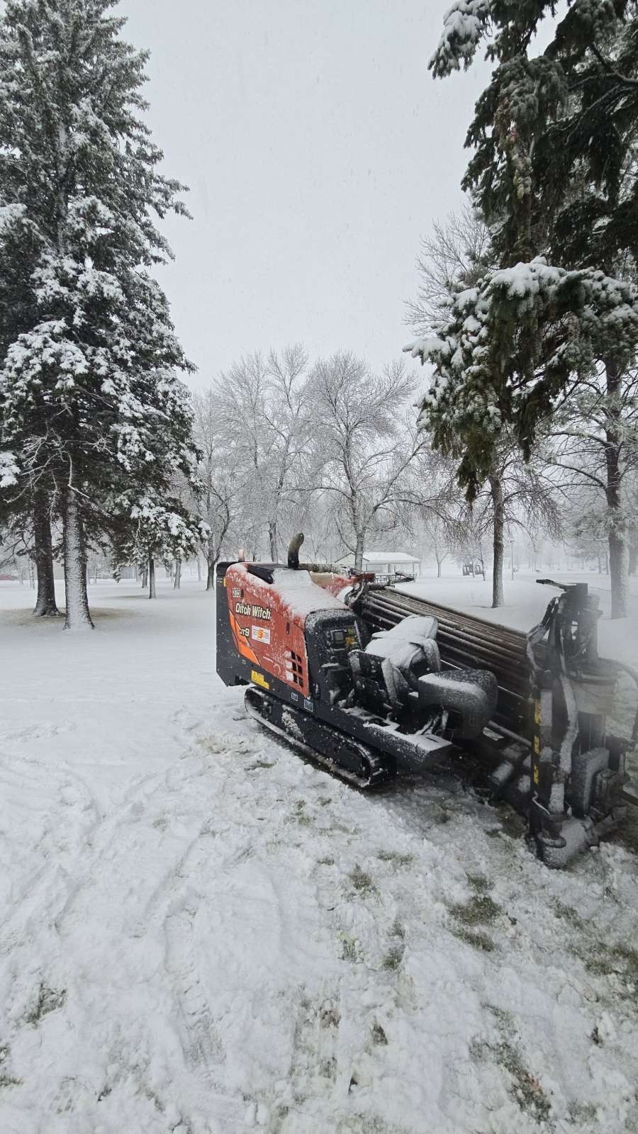 Ditch Witch directional drill installing underground utilities in winter in west-central Minnesota